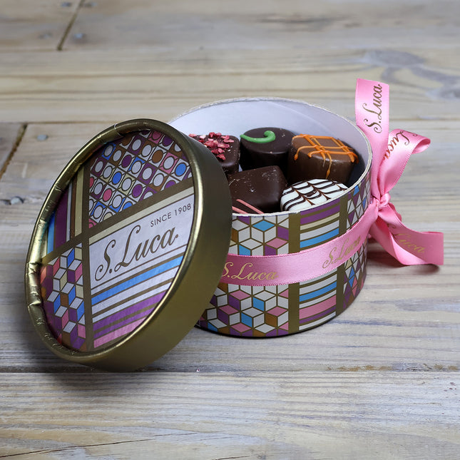 Selection of fine chocolates in a geometric pattern theatre gift box