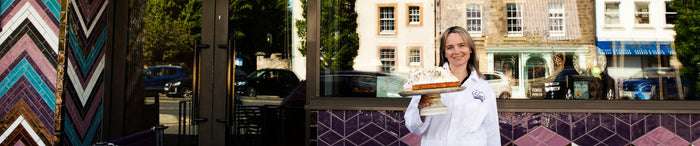 Woman holding ice cream cake outside S Luca